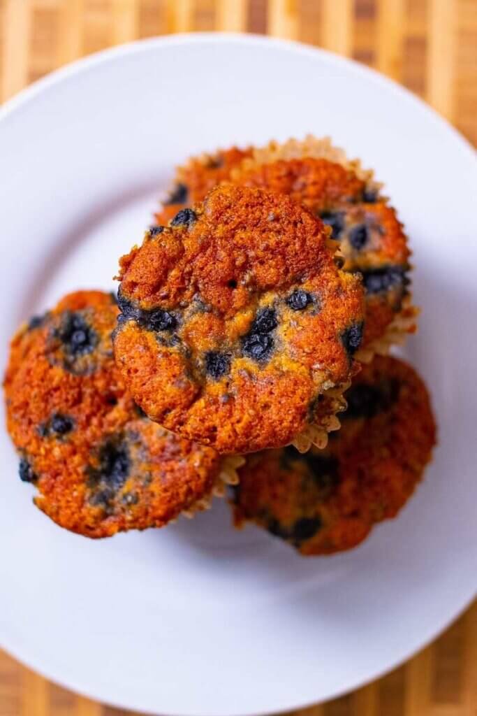top view of a stack of blueberry chia muffins on a white plate