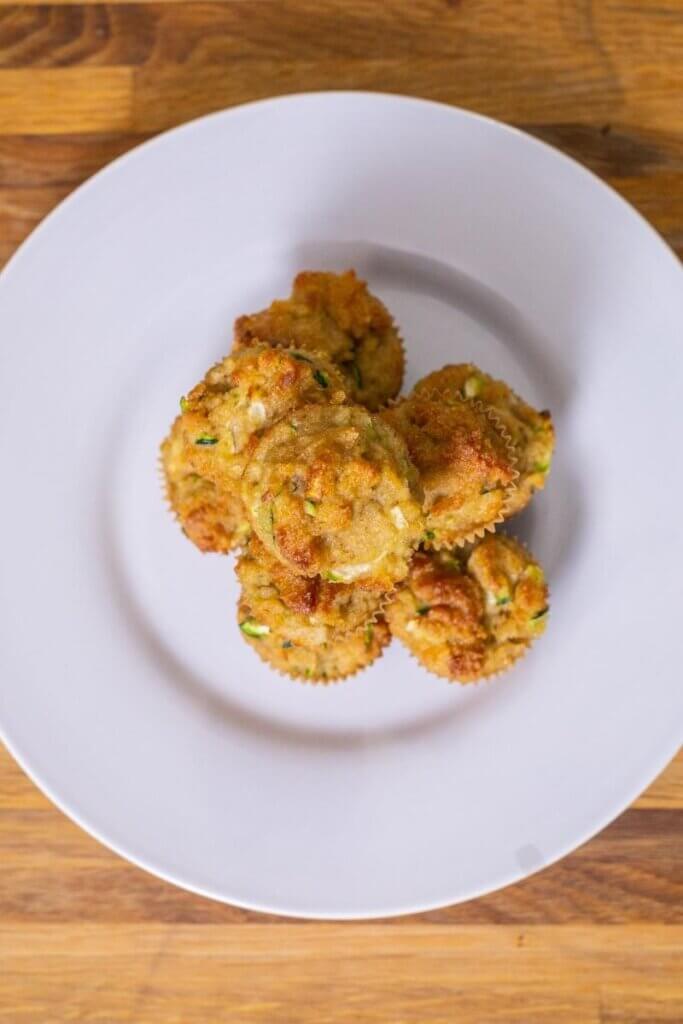top shot of almond flour zucchini muffins on a white plate