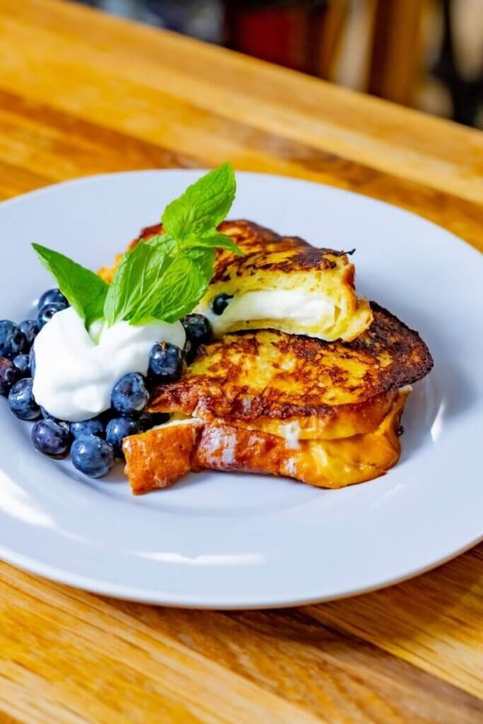 side view of blueberry stuffed french toast on challah bread