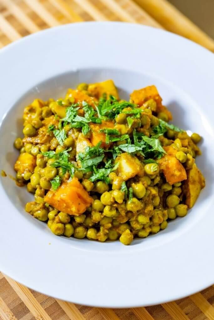 close up of a bowl filled with green peas curry
