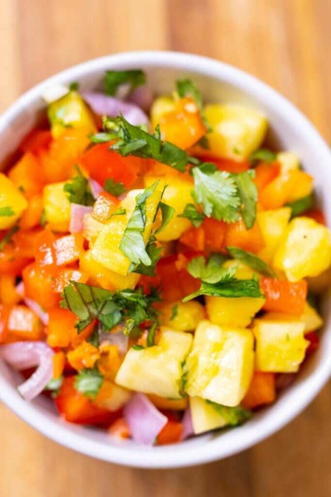 top view of pineapple habanero salsa in a white bowl