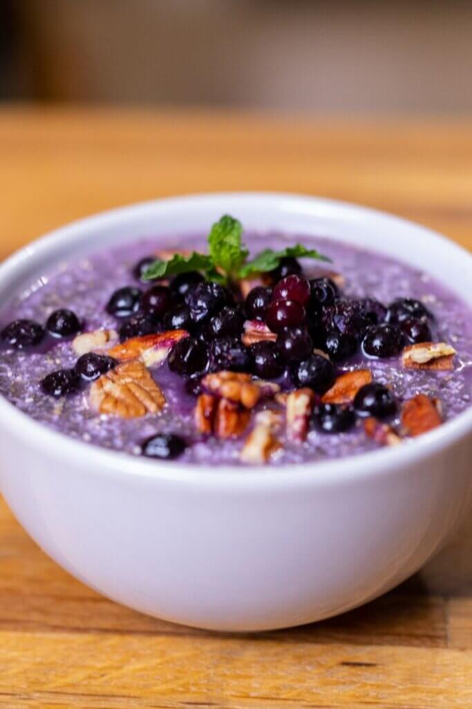 side view of warm chia pudding in a white bowl