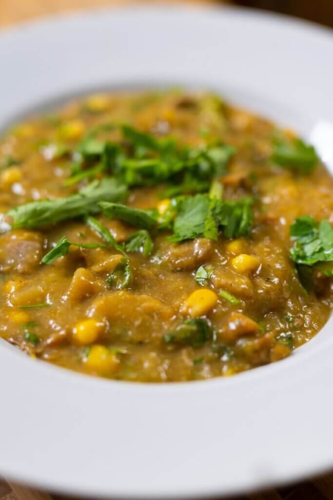side view of a big white bowl filled with vegan sancocho.
