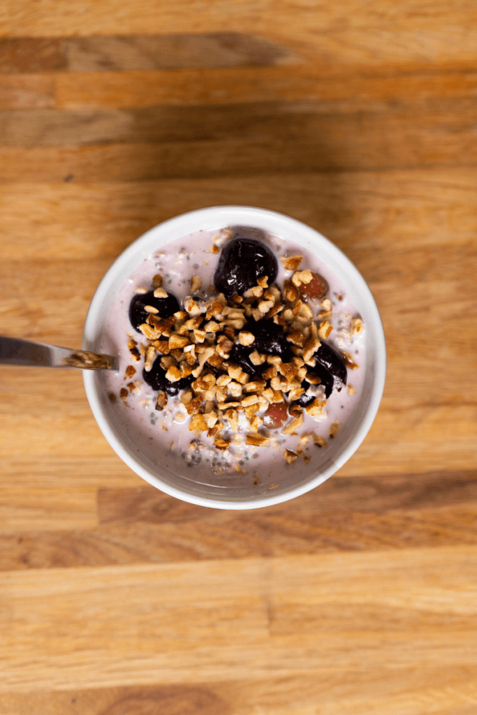 top view of a bowl of cherry overnight oats topped with nuts.