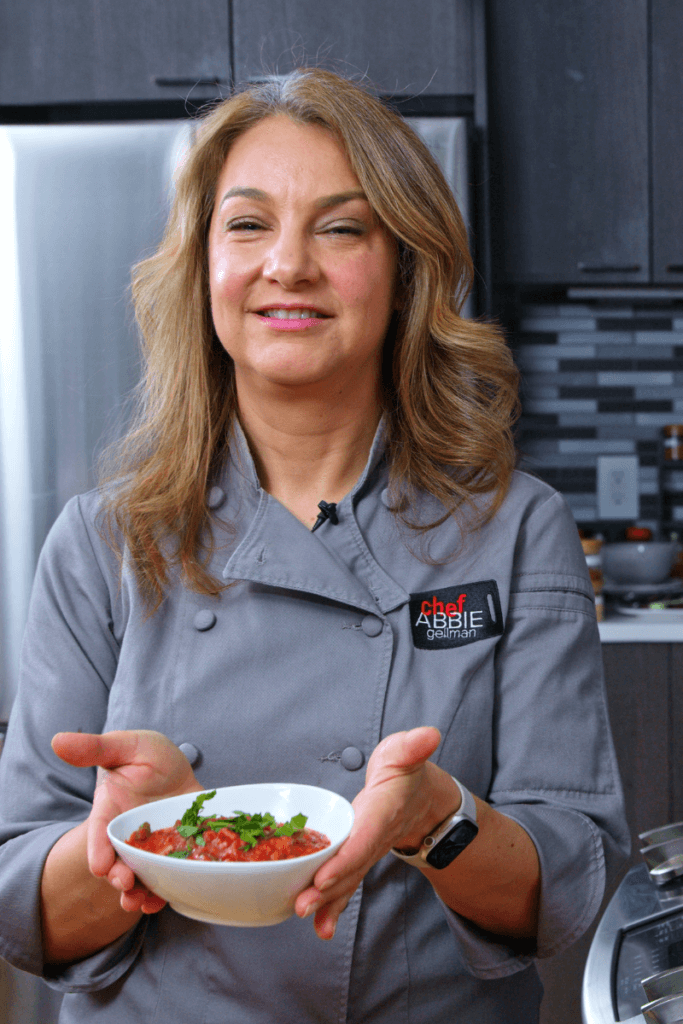 Abbie holding a bowl of tempeh bolognese.