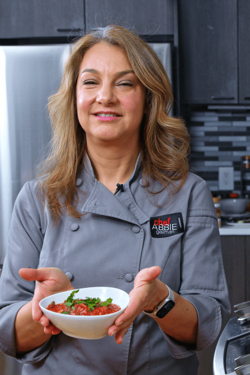 Abbie holding a bowl of tempeh bolognese.