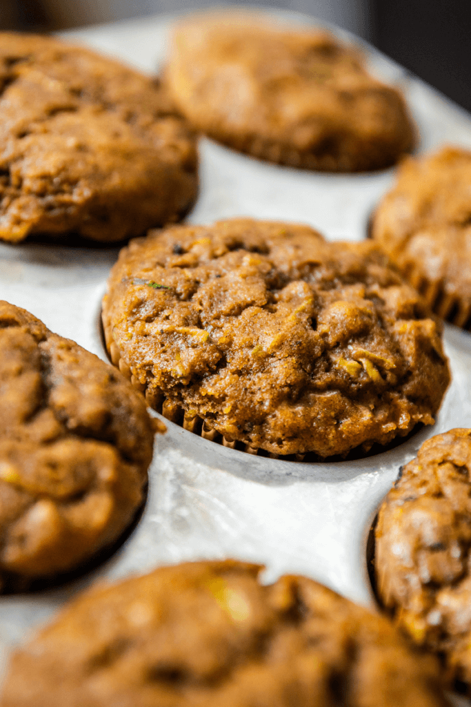 Sweet potato zucchini muffins in a muffin tin.