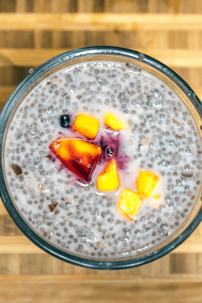 Cherry chia pudding in a glass bowl topped with more cherries.
