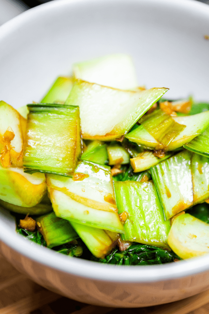 Quick braised bok choy in a white bowl. 