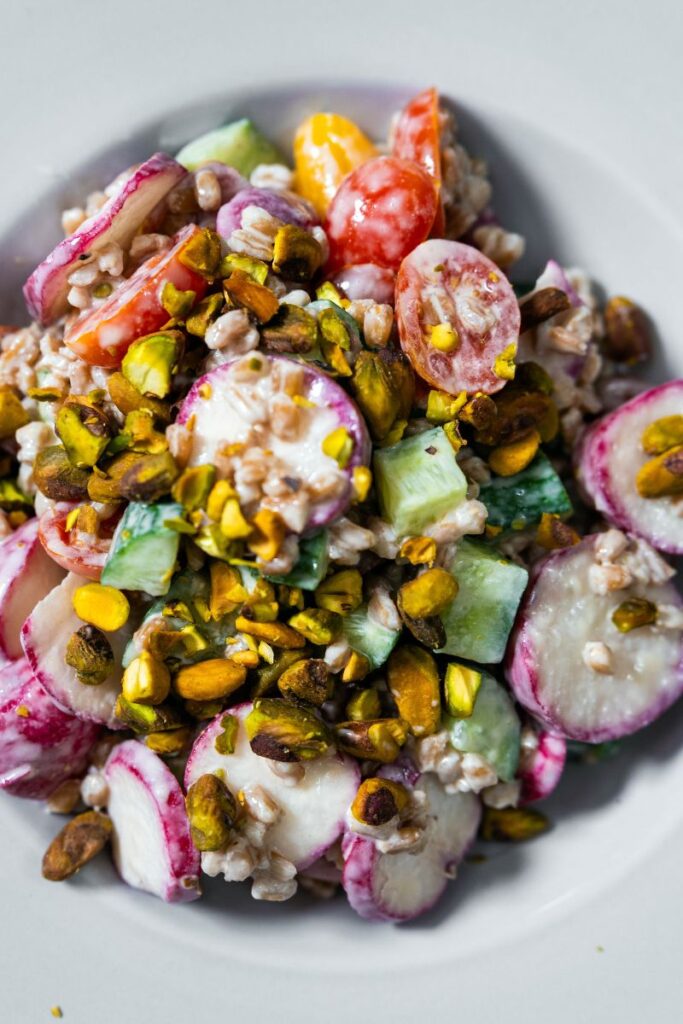 Top view of a farro salad tossed in a tahini dressing.